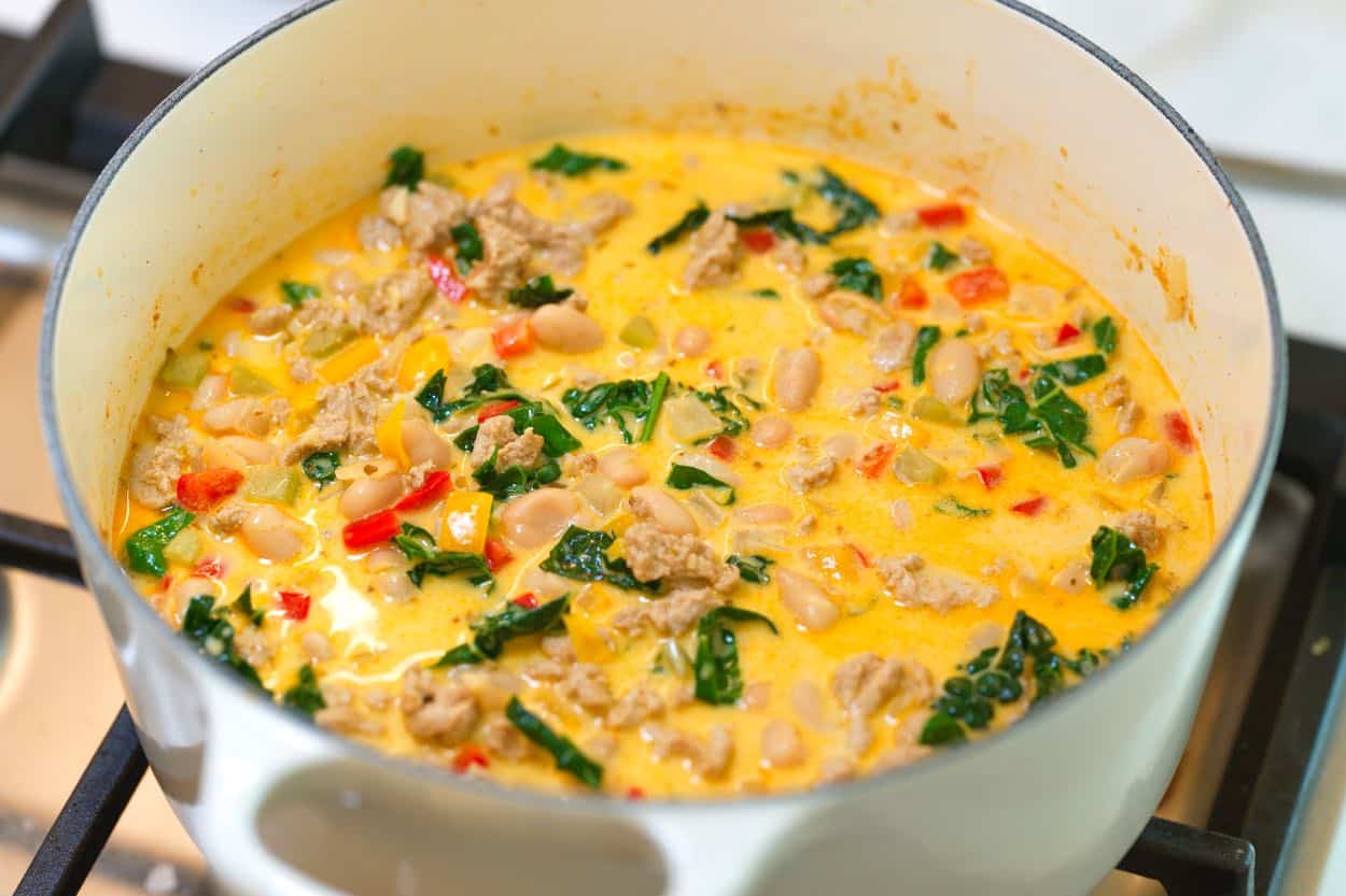 A pot of white turkey chili simmering on the stove
