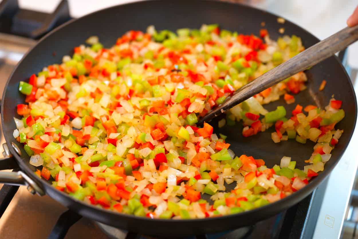 Cooking onions and bell pepper in the same skillet as browning the pork sausage for added flavor.