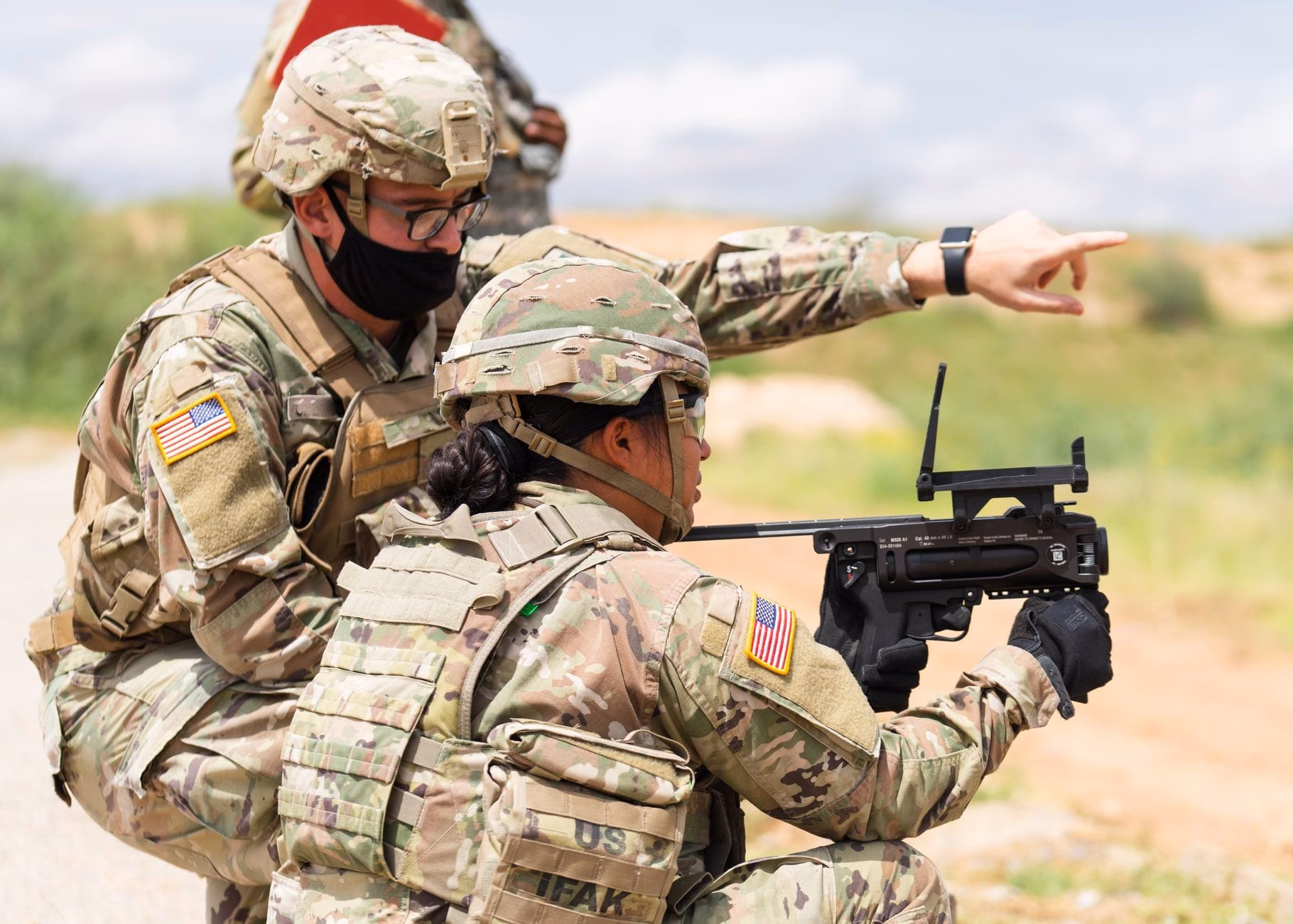 Two US soldiers engage in outdoor combat training, focusing on weapon proficiency.