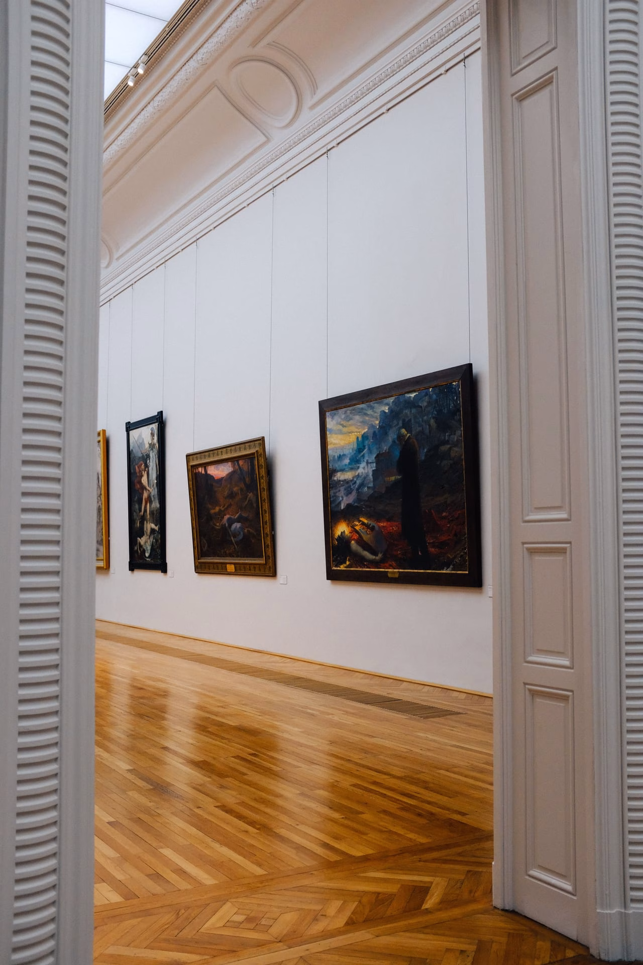 Explore the elegance of an art gallery interior with framed paintings on display.